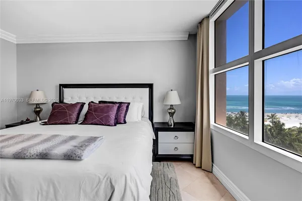 a bedroom with a bed and a large window