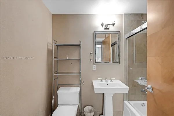 a bathroom with a sink mirror and toilet