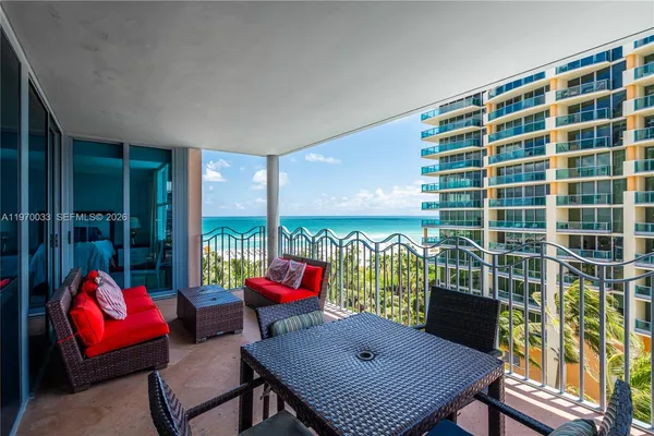 a view of a balcony with furniture and a terrace view