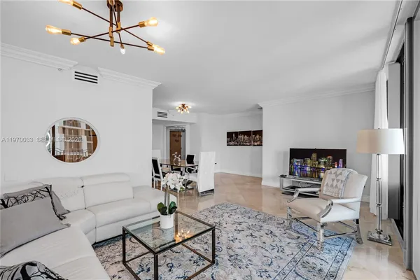 a living room with furniture a rug and a window