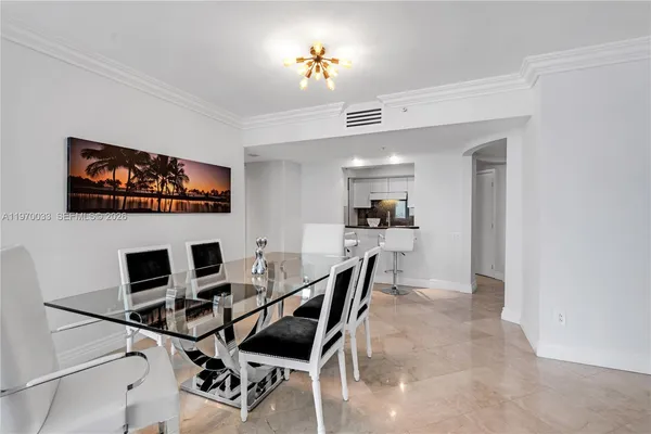 a dining room with furniture and a flat screen tv