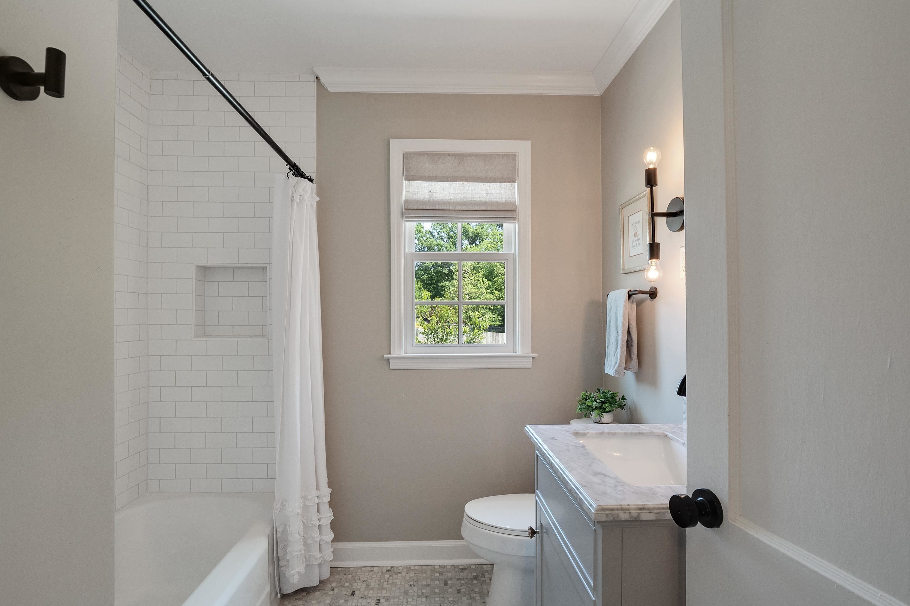 4800 Barfield Road Memphis, TN 38117 - Photo 14 of 25 a bathroom with a granite countertop sink toilet and shower