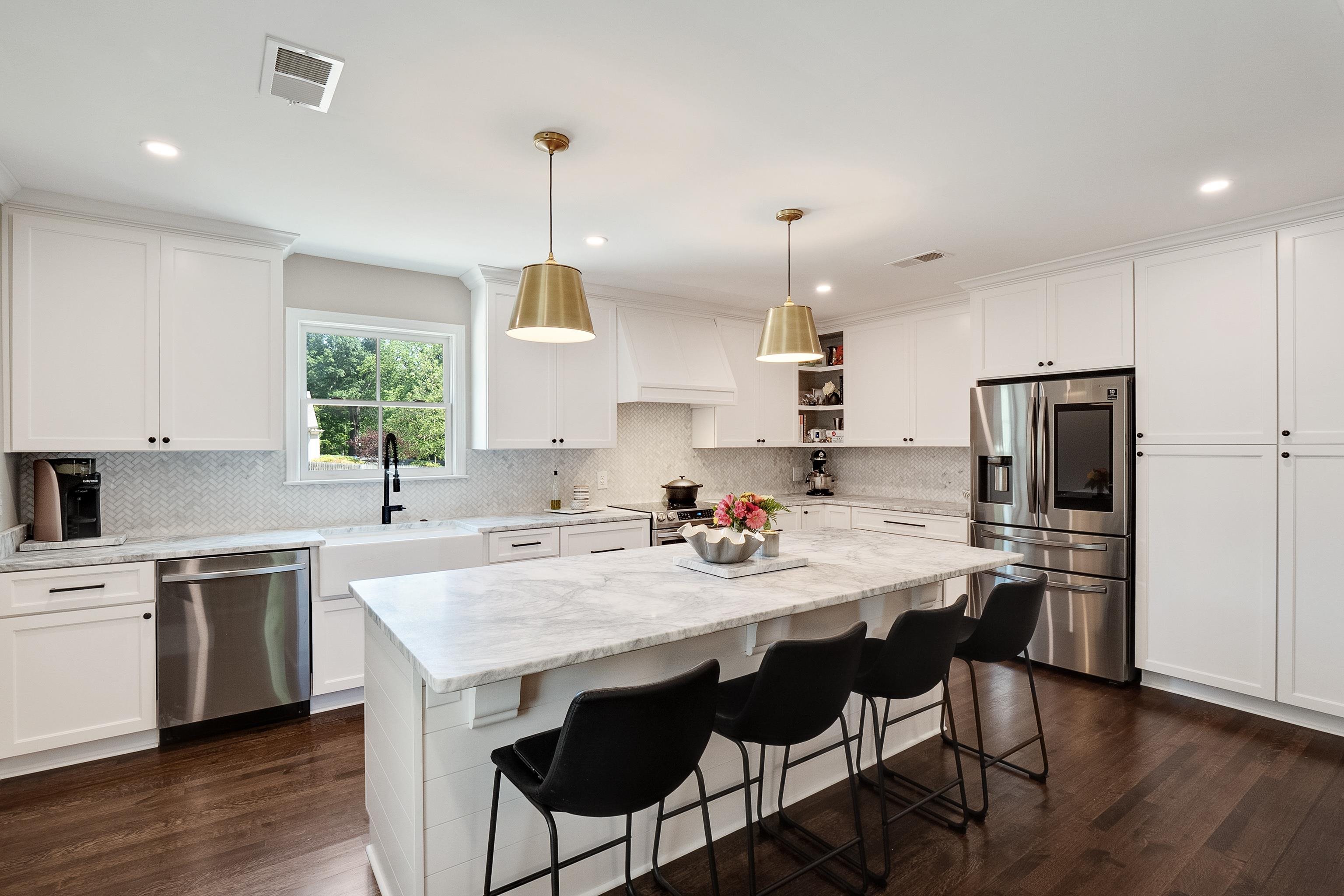 4800 Barfield Road Memphis, TN 38117 - Photo 5 of 25 a kitchen with a sink a stove a refrigerator and white cabinets with wooden floor
