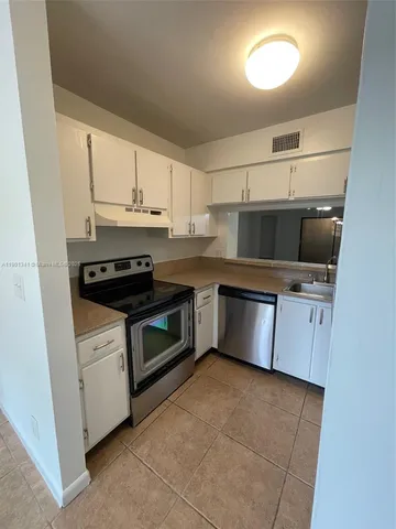 a view of an empty room and a fireplace