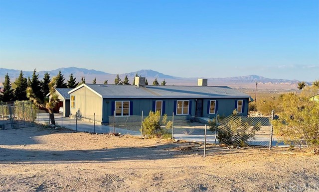 32540 Zircon Road Lucerne Valley, CA 92356 - Photo 1 of 1 a front view of a house with garden