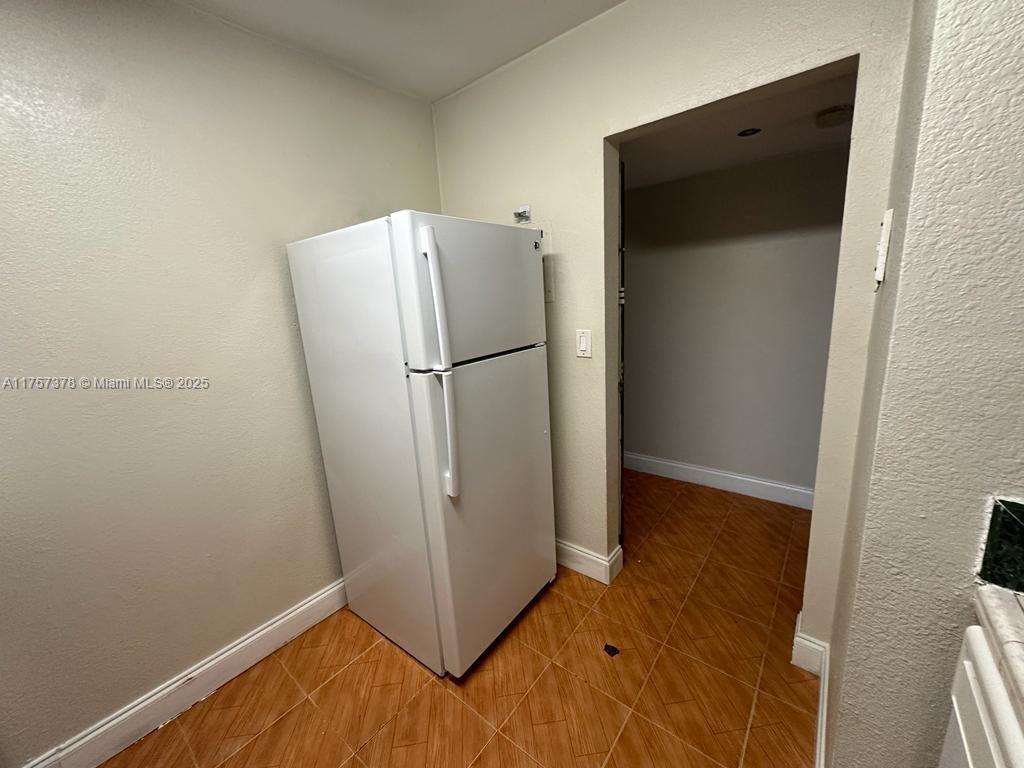 492 Northwest 165th Street, Unit C211 Miami, FL 33169 - Photo 12 of 26 a view of a refrigerator in kitchen and hardwood floor