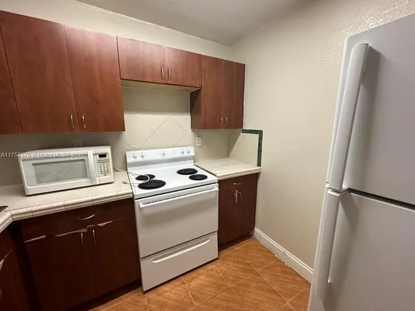 a kitchen with a sink and a stove top oven