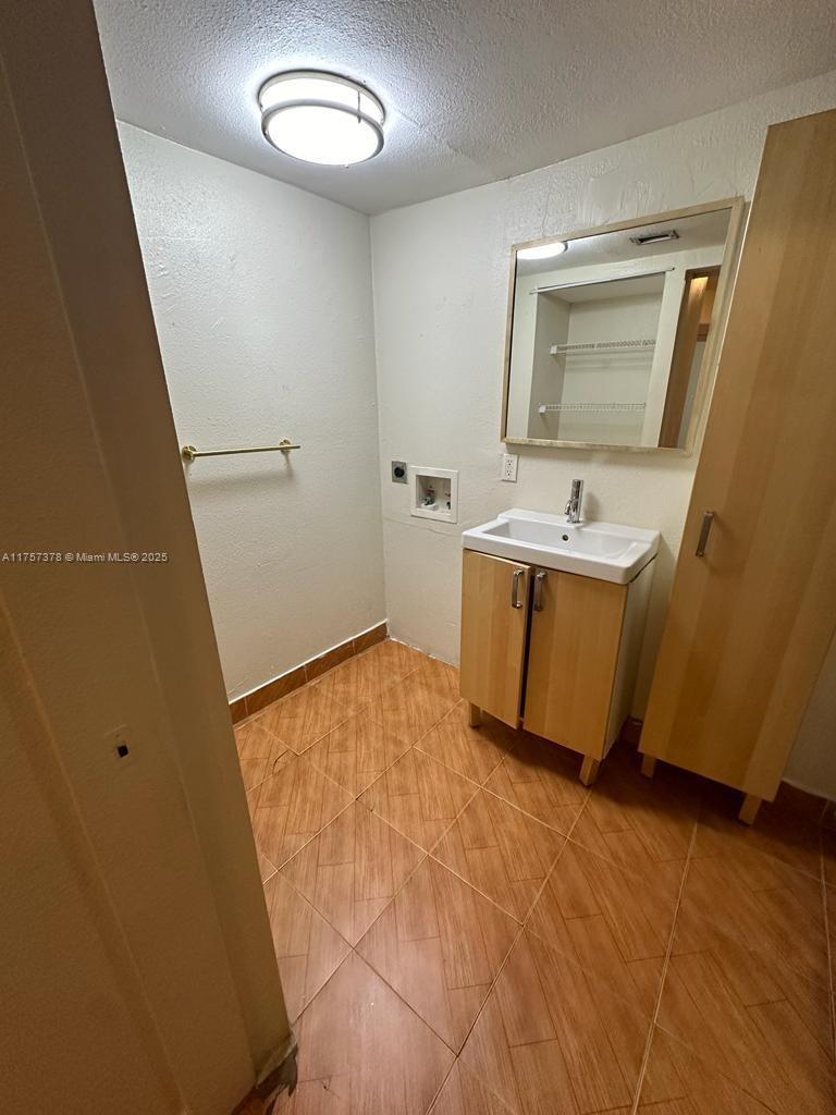492 Northwest 165th Street, Unit C211 Miami, FL 33169 - Photo 17 of 26 a view of a room with wooden floor and cabinet