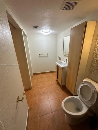 a bathroom with a double vanity sink toilet and shower