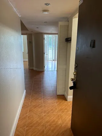 wooden floor in an empty room with a bathroom