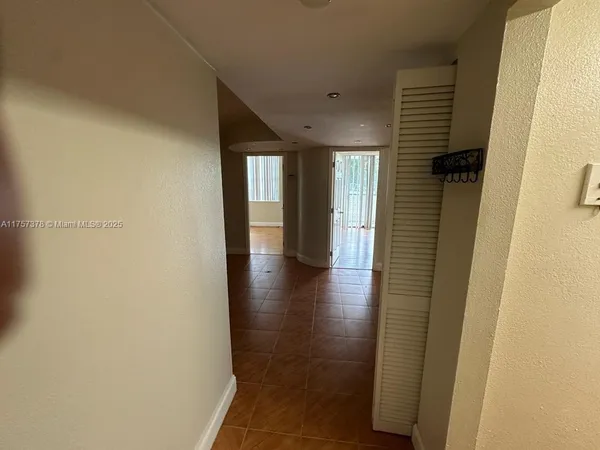 a view of hallway with stairs and wooden floor