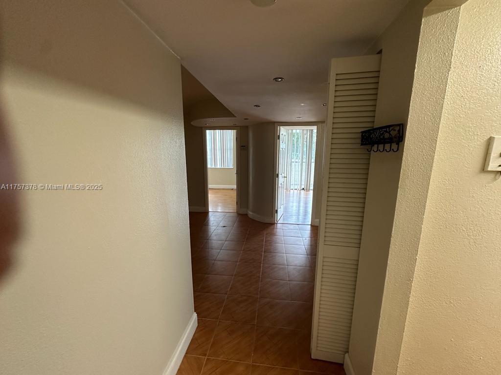492 Northwest 165th Street, Unit C211 Miami, FL 33169 - Photo 8 of 26 a view of hallway with stairs and wooden floor