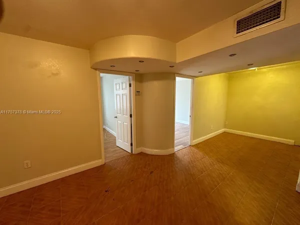 a view of an empty room with a window