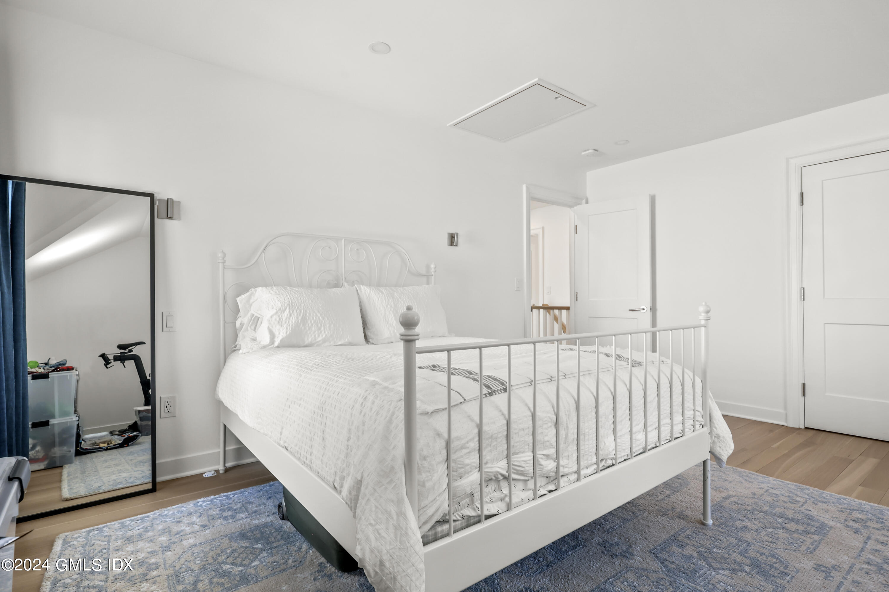 18 Annjim Drive Greenwich, CT 06830 - Photo 14 of 23 a bed sitting in a bedroom next to a bathroom with a sink