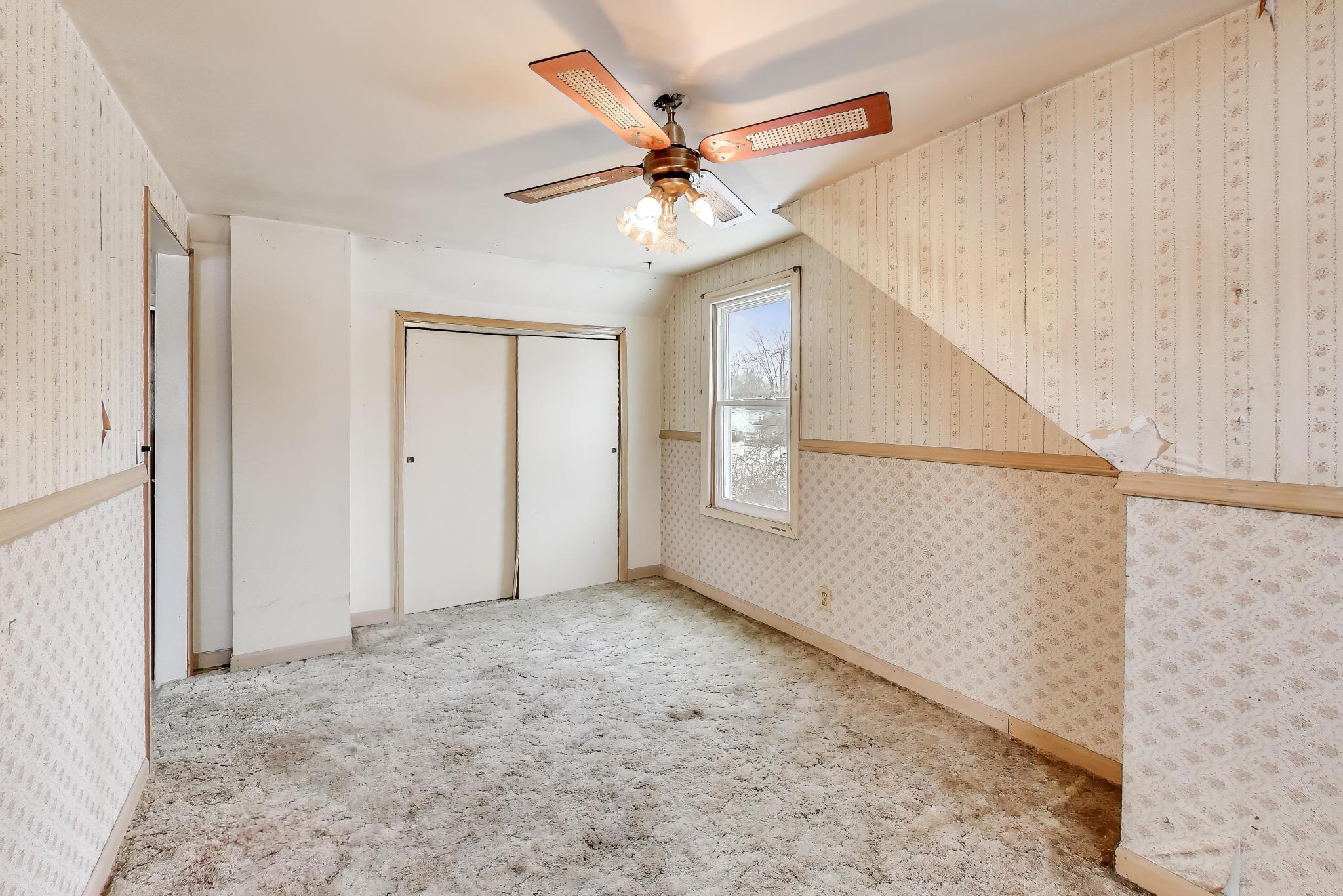 3561 Liverpool Road Lake Station, IN 46405 - Photo 12 of 16 a view of a livingroom with a ceiling fan and window
