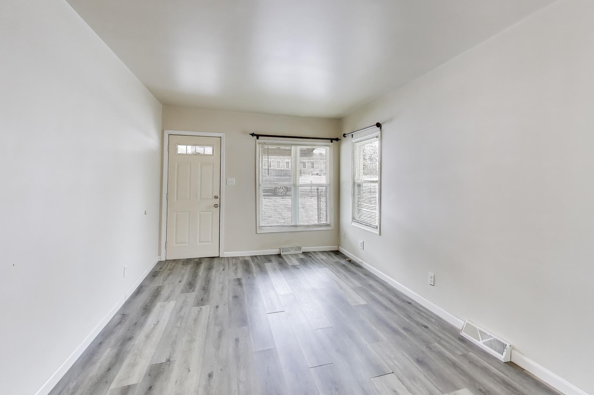 3561 Liverpool Road Lake Station, IN 46405 - Photo 3 of 16 an empty room with wooden floor and windows