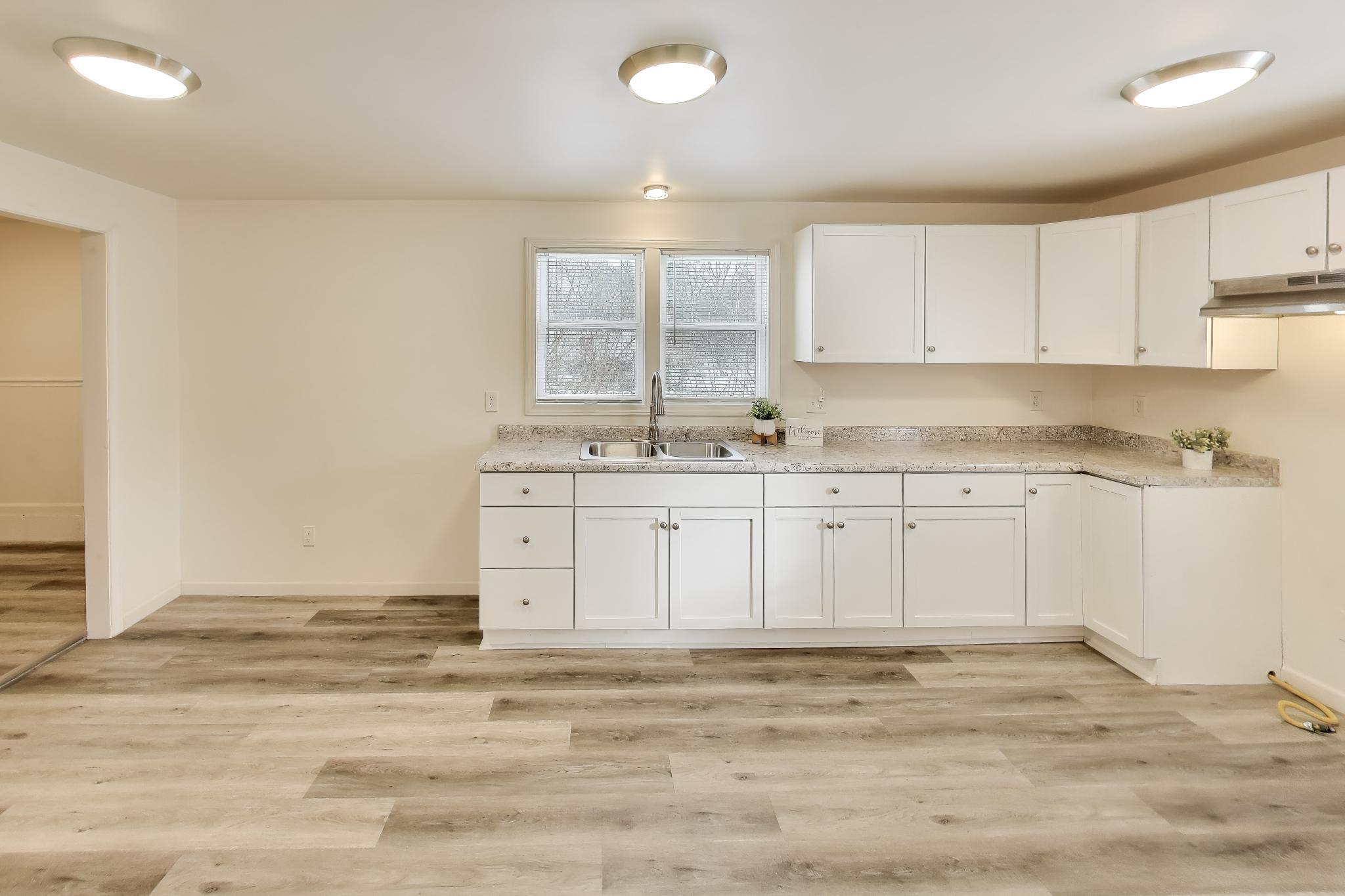 3561 Liverpool Road Lake Station, IN 46405 - Photo 4 of 16 a view of a kitchen with white cabinets