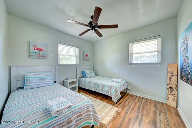 a bedroom with two beds and a window