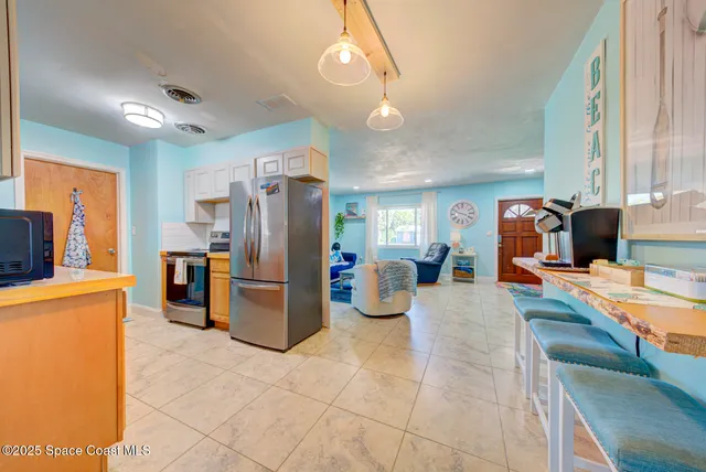 a large kitchen with a large counter top appliances and cabinets