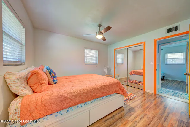 a bedroom with a bed and wooden floor