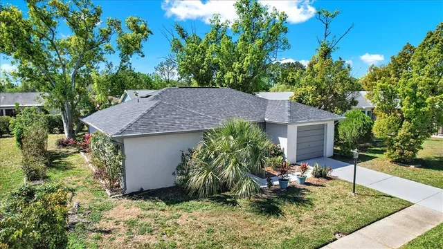 a backyard of a house with table and chairs