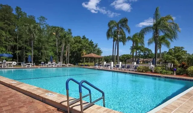 a view of a swimming pool with a table and chairs