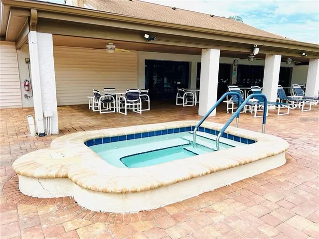 a view of a swimming pool with a lounge chair