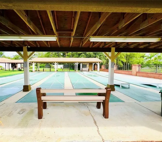 a view of a porch with a table and chairs