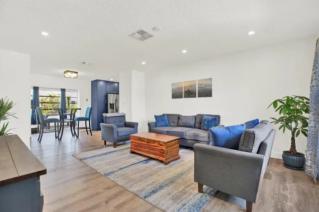 a living room with furniture and wooden floor