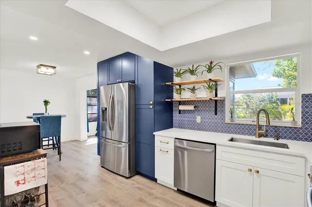 a kitchen that has a lot of counter space and a refrigerator