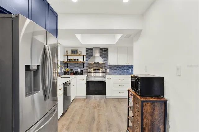 a kitchen with stainless steel appliances a refrigerator sink and stove
