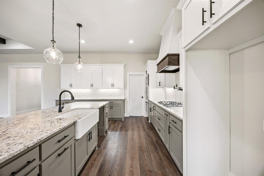 13835 Cashs Mill Road Sanger, TX 76266 - Photo 12 of 32 a large kitchen with granite countertop a stove and a sink