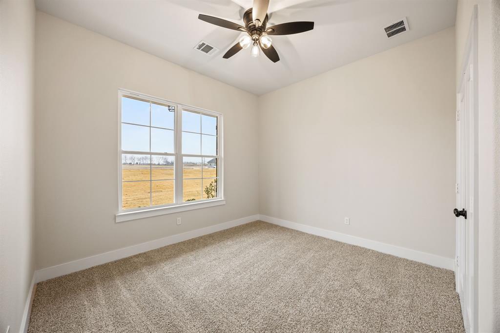 13835 Cashs Mill Road Sanger, TX 76266 - Photo 17 of 32 an empty room with a window and a fan