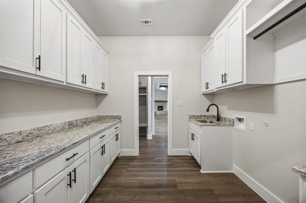 13835 Cashs Mill Road Sanger, TX 76266 - Photo 27 of 32 a kitchen with granite countertop a sink stove and cabinets