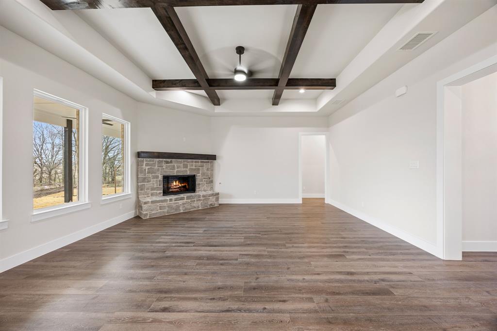 13835 Cashs Mill Road Sanger, TX 76266 - Photo 5 of 32 a view of an empty room with wooden floor fireplace and a window