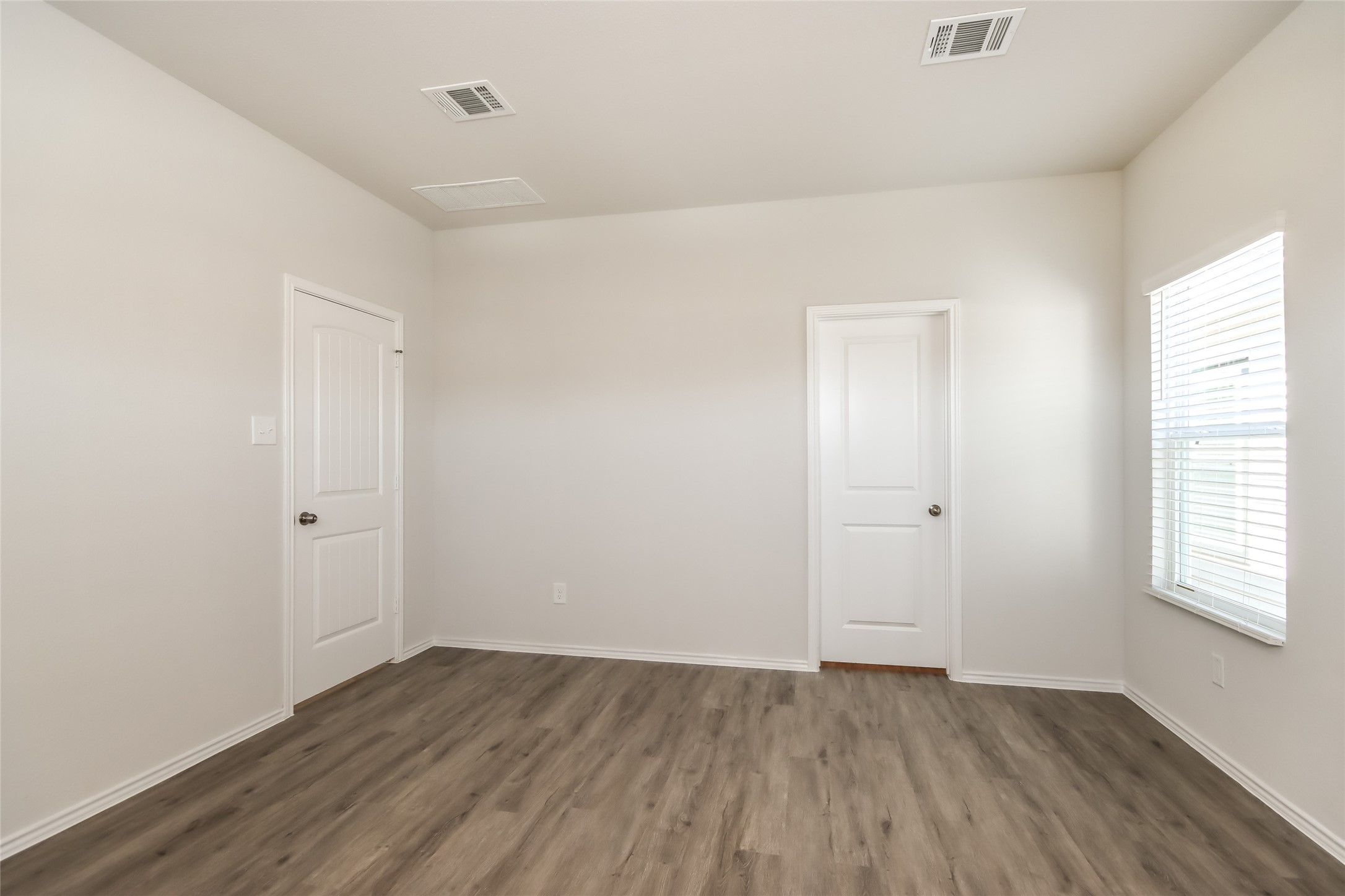 15226 Estrella Road West Houston, TX 77073 - Photo 7 of 13 an empty room with wooden floor and windows