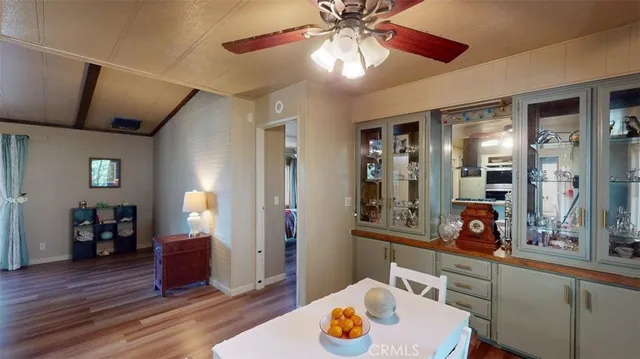 a kitchen that has a lot of cabinets in it and wooden floors