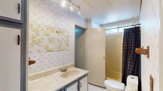 a view of an empty room and wooden floor and a window