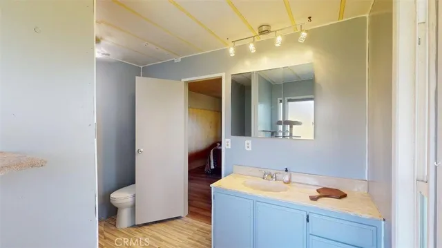 a room with wooden floor and windows