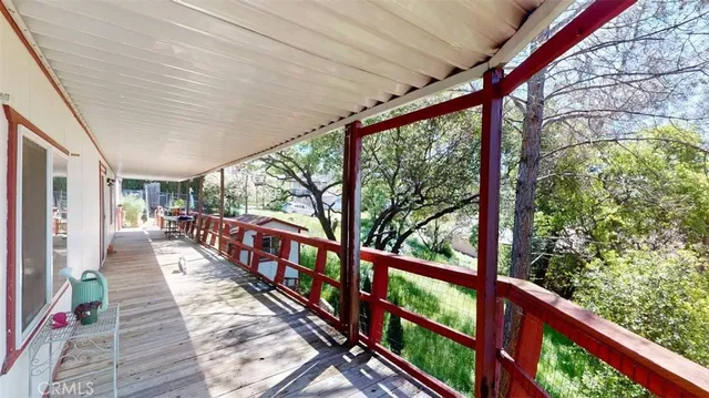 a view of a room with wooden floor and furniture