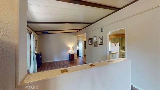 a view of a living room with furniture and wooden floor