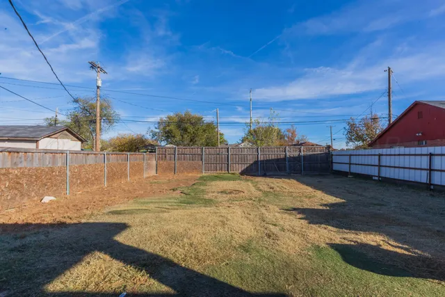 a view of a house with a yard and garage