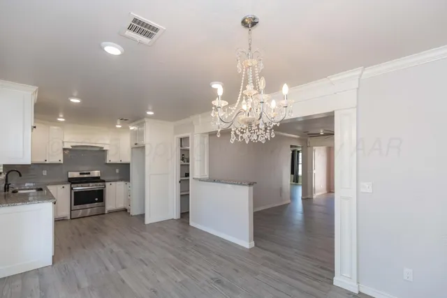 a view of a kitchen with stove and refrigerator