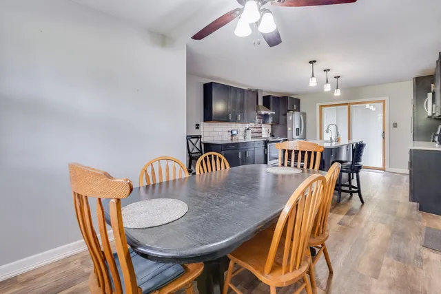 a dining room with furniture and wooden floor
