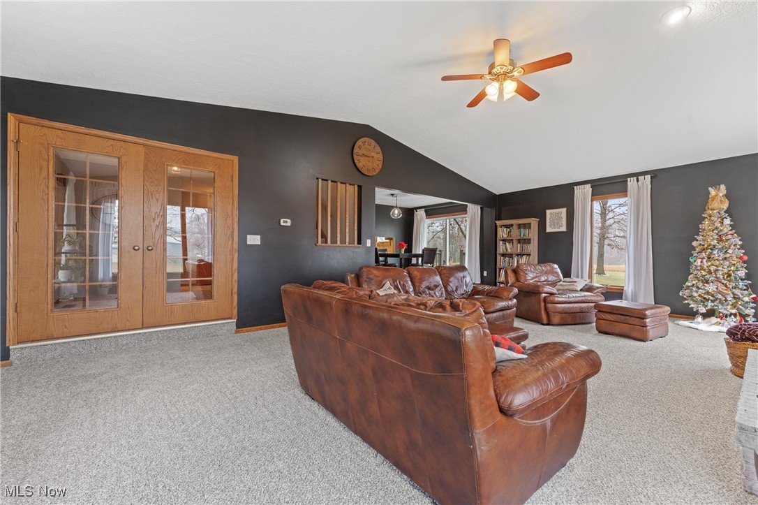 645 Killinger Road Clinton, OH 44216 - Photo 20 of 50 Living room featuring french doors, carpet floors, ceiling fan, and lofted ceiling