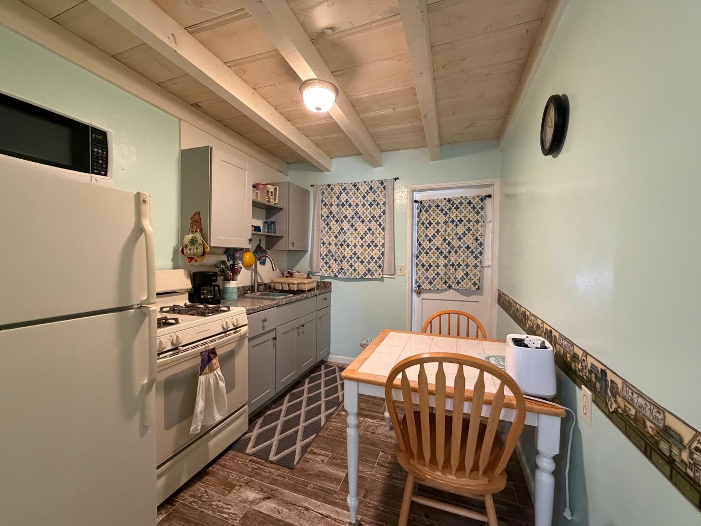 9502 North 2nd Place Phoenix, AZ 85020 - Photo 11 of 21 a kitchen with stainless steel appliances a refrigerator a sink a stove and white cabinets