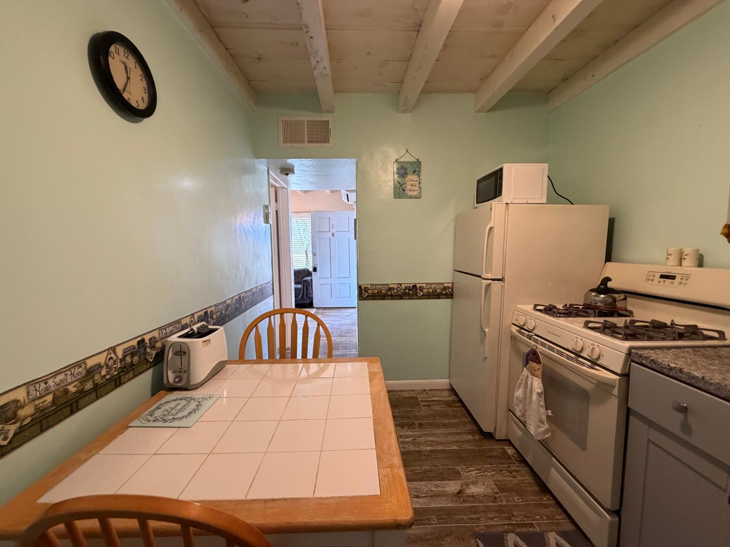 9502 North 2nd Place Phoenix, AZ 85020 - Photo 12 of 21 a kitchen with a refrigerator and a stove top oven