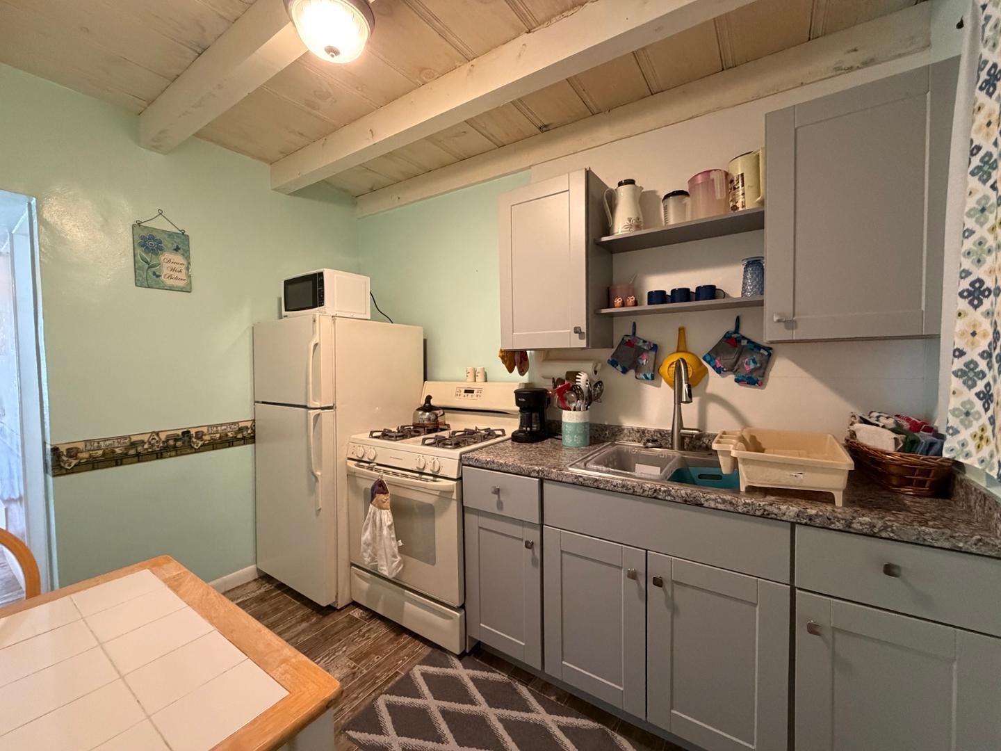 9502 North 2nd Place Phoenix, AZ 85020 - Photo 19 of 21 a kitchen with a sink appliances and cabinets