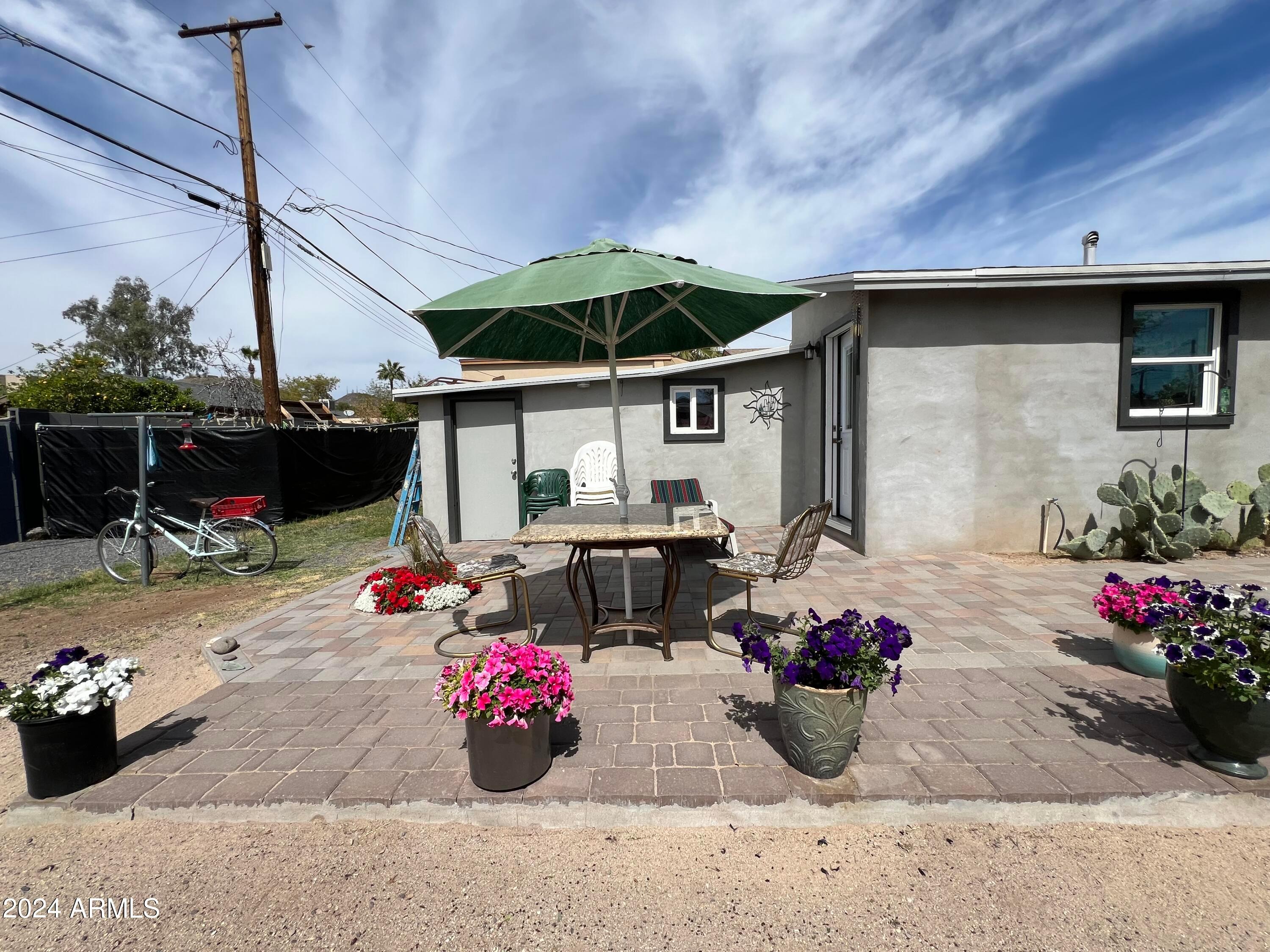 9502 North 2nd Place Phoenix, AZ 85020 - Photo 7 of 21 a view of a patio with table and chairs potted plants