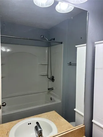 a bathroom with a bathtub and shower